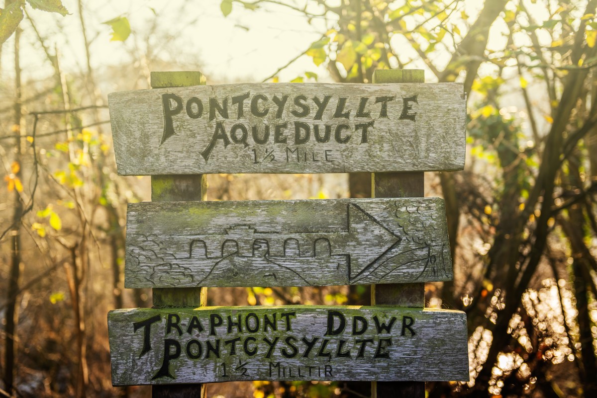 Signs for Pontcysyllte Aqueduct which is a navigable aqueduct that carries the Llangollen Canal across the River Dee in the Vale of Llangollen in north east Wales, UK